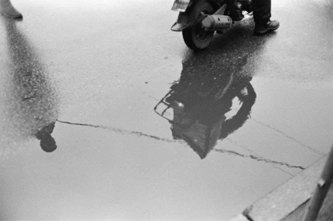 black and white motorcycle on road