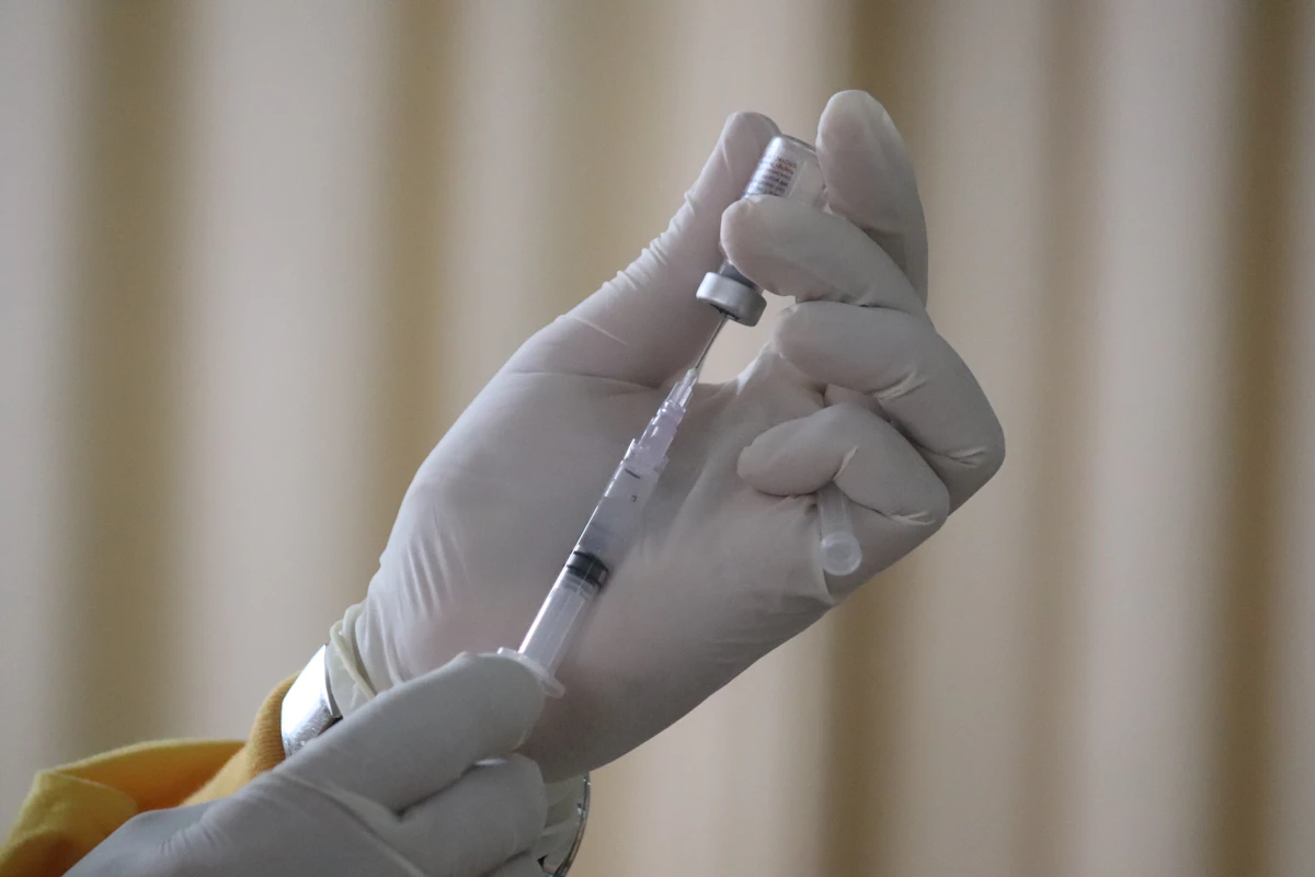 Insulin syringe drawing reconstituted peptide solution from a vial after mixing with bacteriostatic water