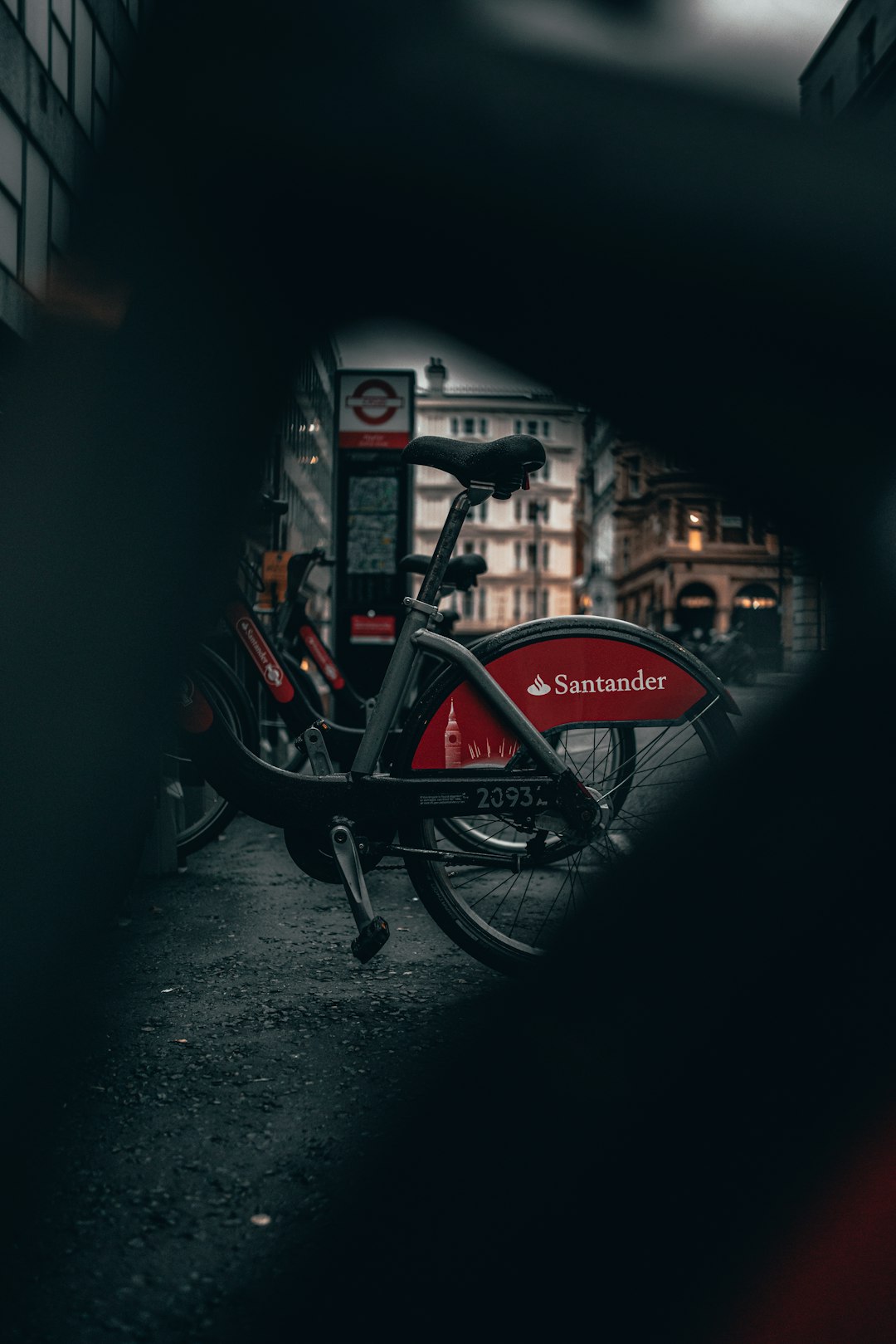 red and black bicycle parked beside building during night time