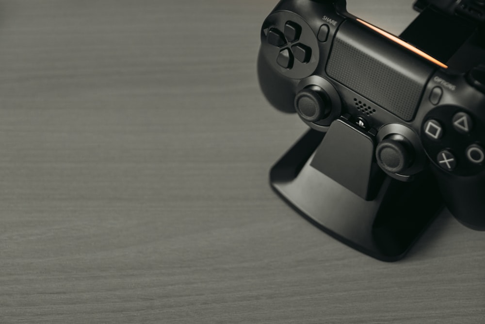 black game controller on brown wooden table