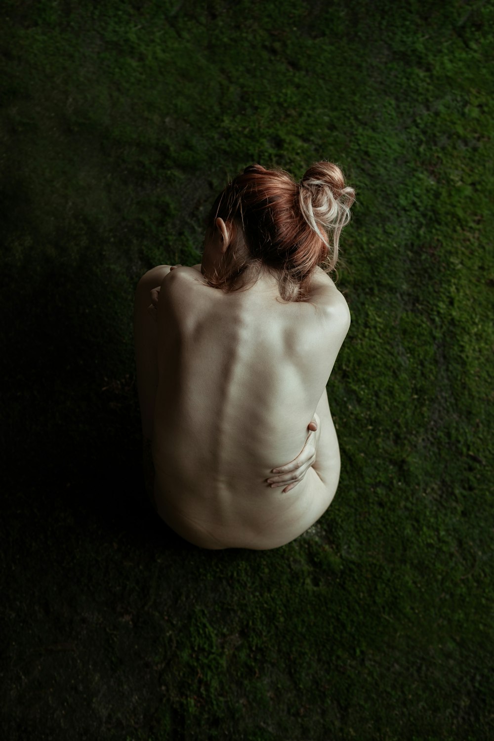 woman in white dress lying on green grass