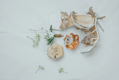 Elegant bridal accessories arranged on a blush pink fabric backdrop, highlighting fine details.