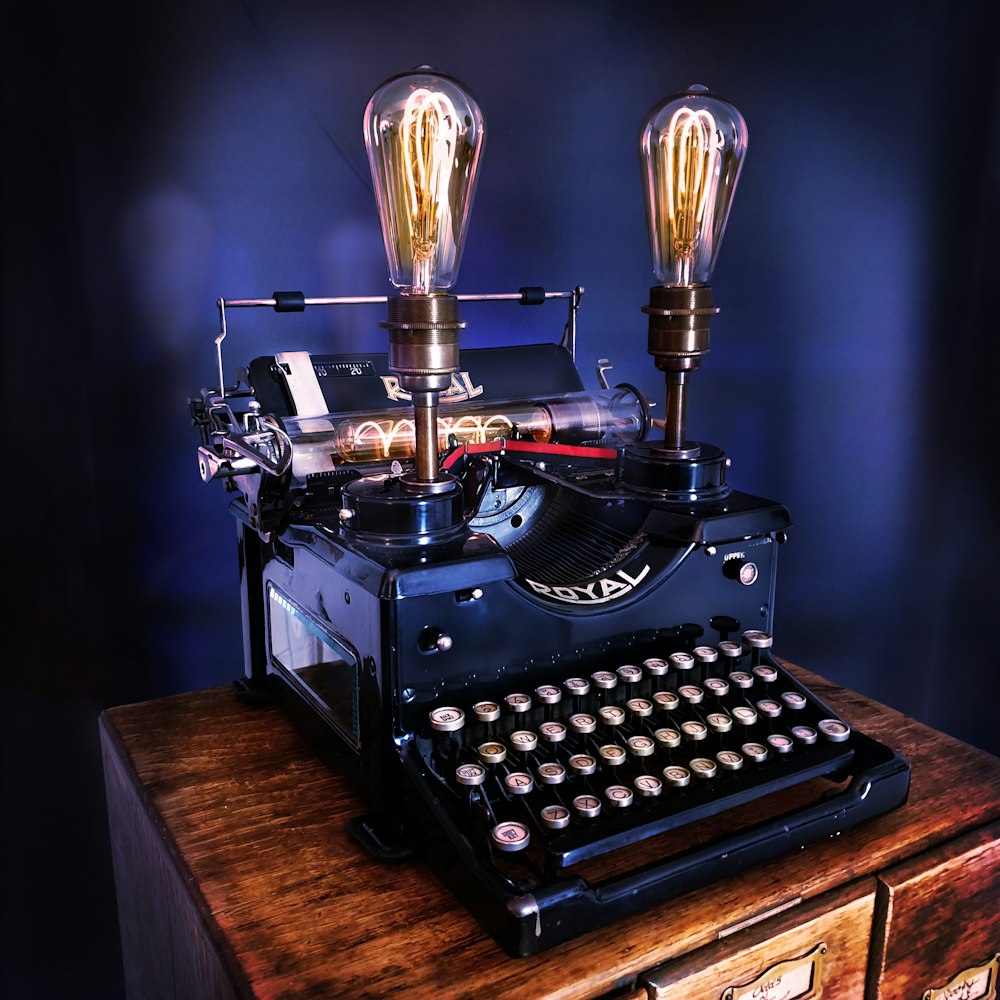 black typewriter on brown wooden table