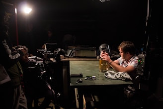 man in white tank top drinking beer