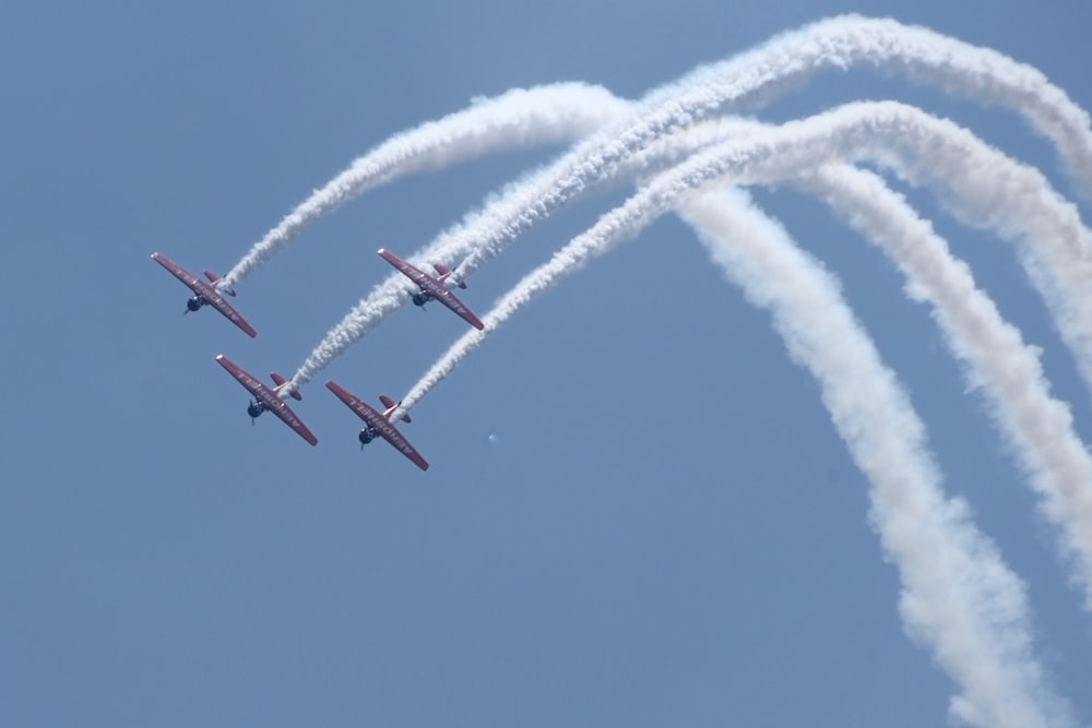 four red jet planes in mid air