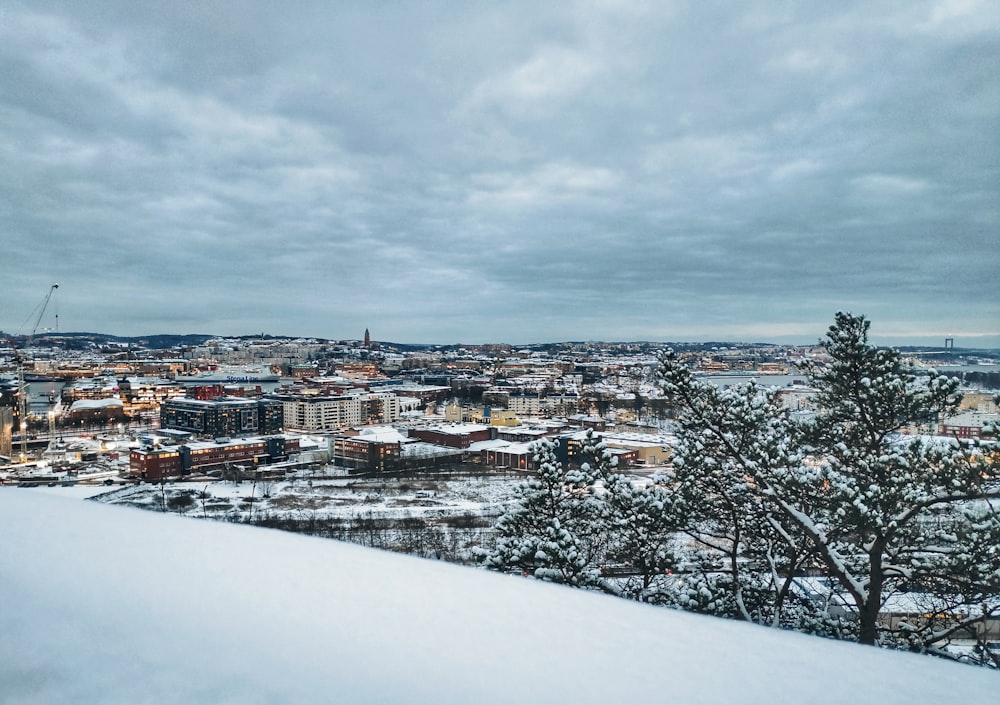 city with snow under gray sky