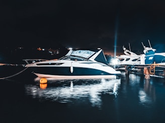 A sleek motorboat docked at a marina during sunset, showcasing polished surfaces.