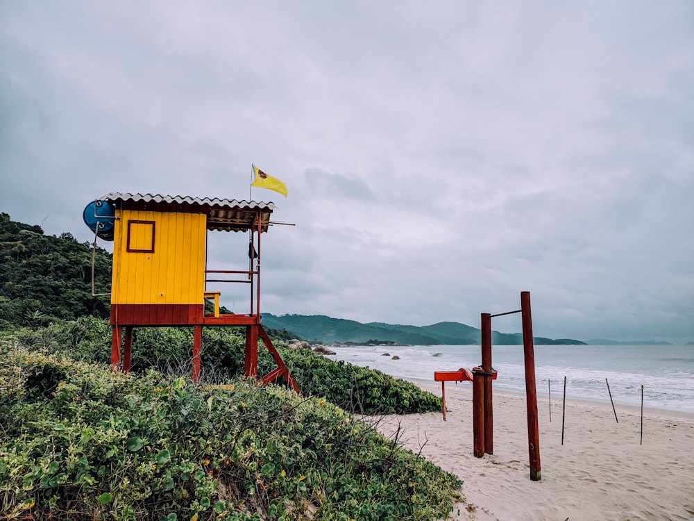 brown wooden lifeguard house on seashore during daytime