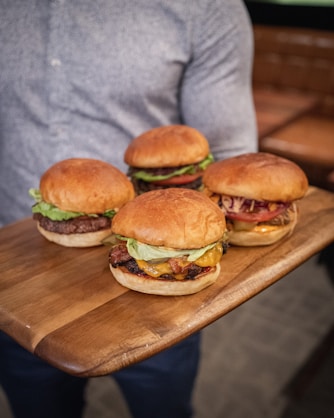 burger on brown wooden chopping board