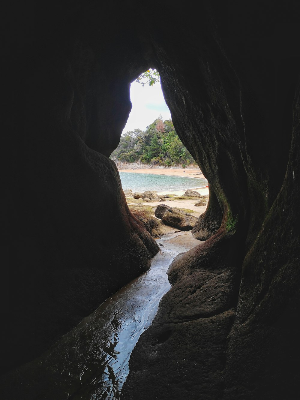 brown rock formation near body of water during daytime