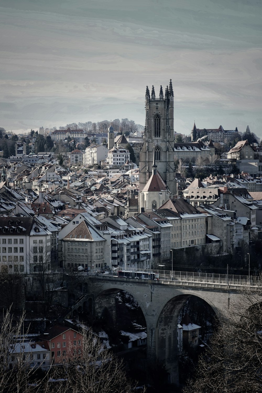 gray concrete bridge over the city during daytime