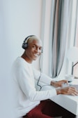 woman in white long sleeve shirt wearing headphones