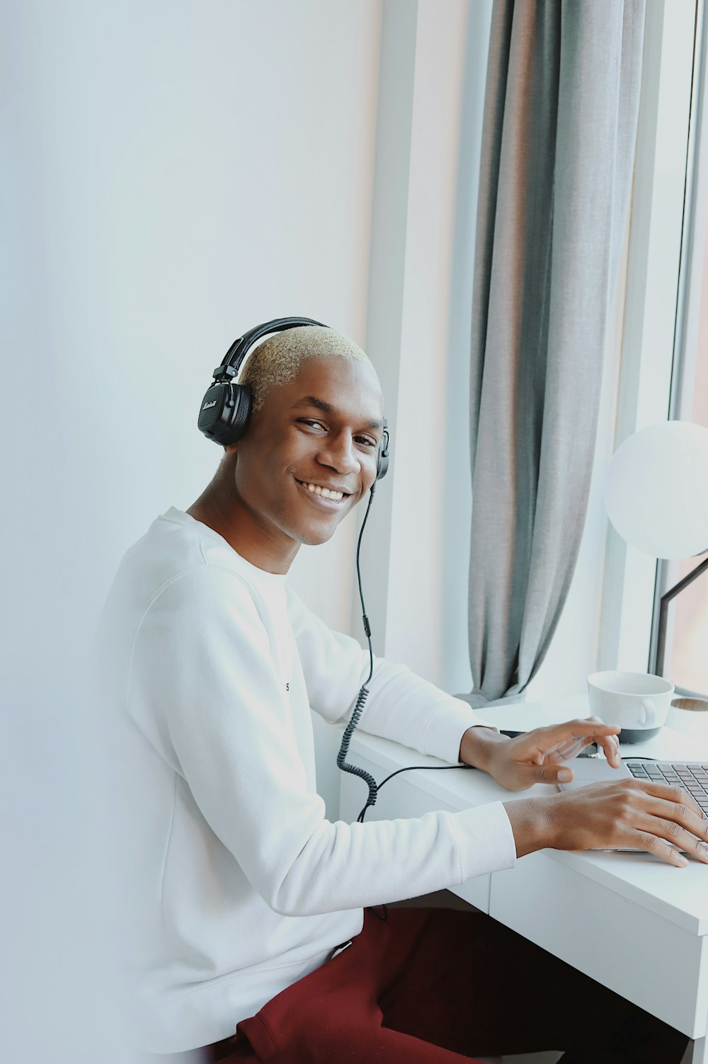 woman in white long sleeve shirt wearing headphones