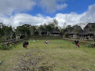 A vibrant community workshop in a lush Indonesian village focusing on education and environmental care.