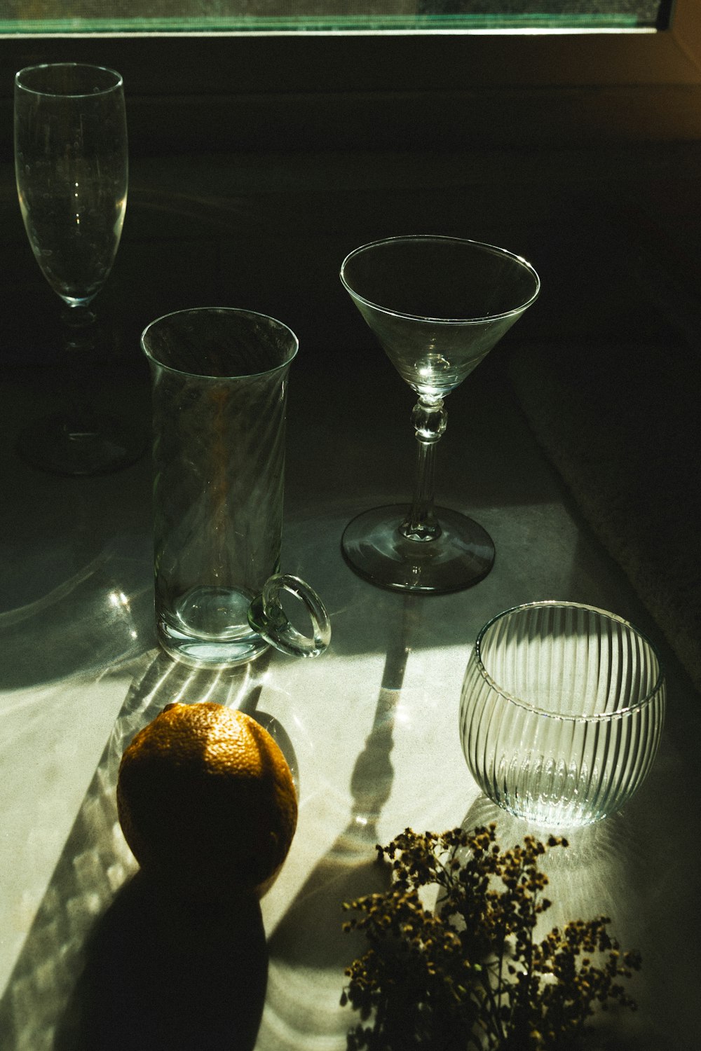 clear wine glass beside clear glass bowl