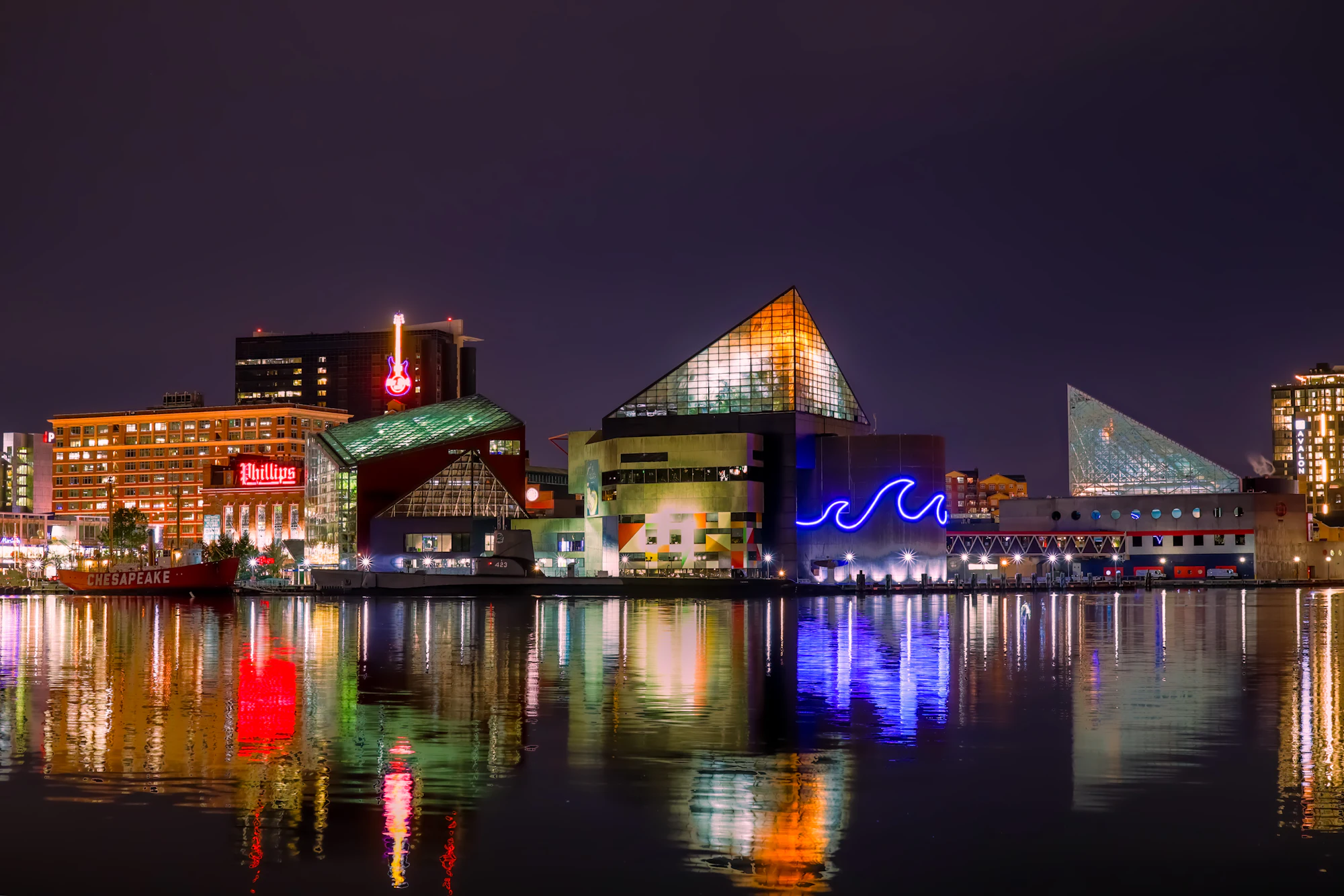 Baltimore waterfront buildings reflected in the harbor at night