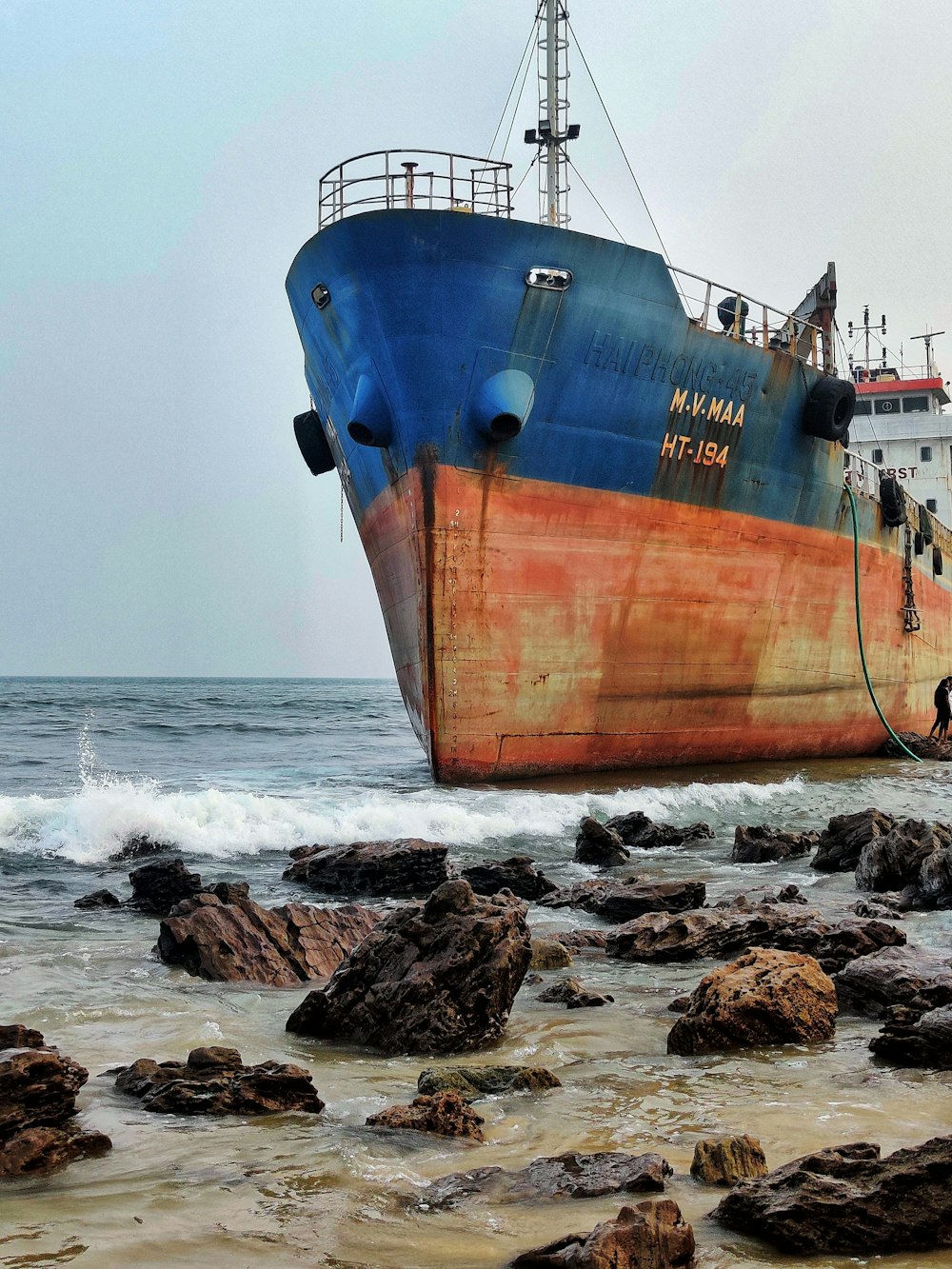 blue and brown ship on sea shore during daytime