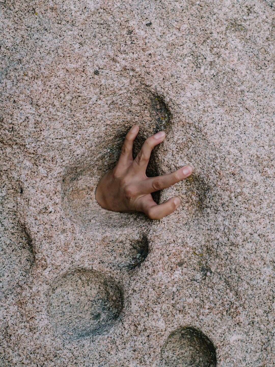persons left hand on gray sand