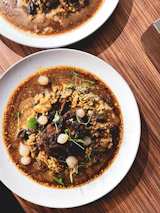 A steaming plate of traditional Hungarian goulash served with rustic bread.