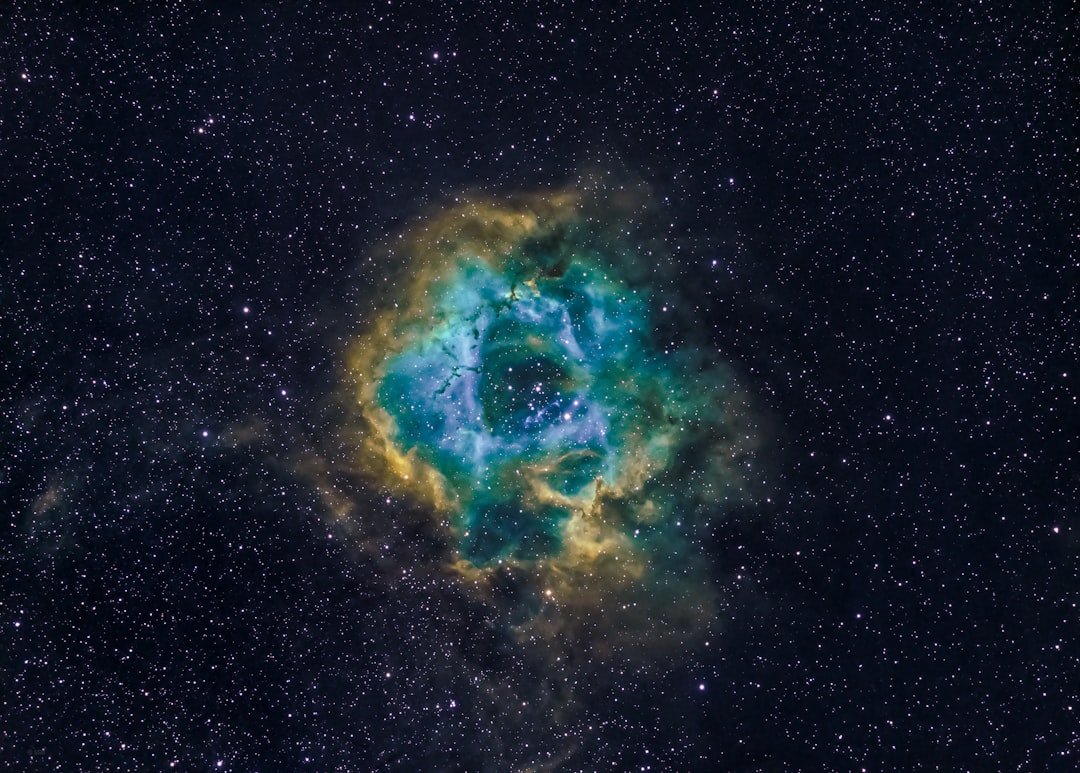 blue and black galaxy illustration, The Rosette nebula in the Hubble palette