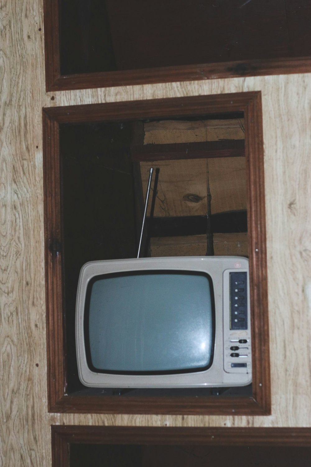 gray crt tv on brown wooden tv hutch