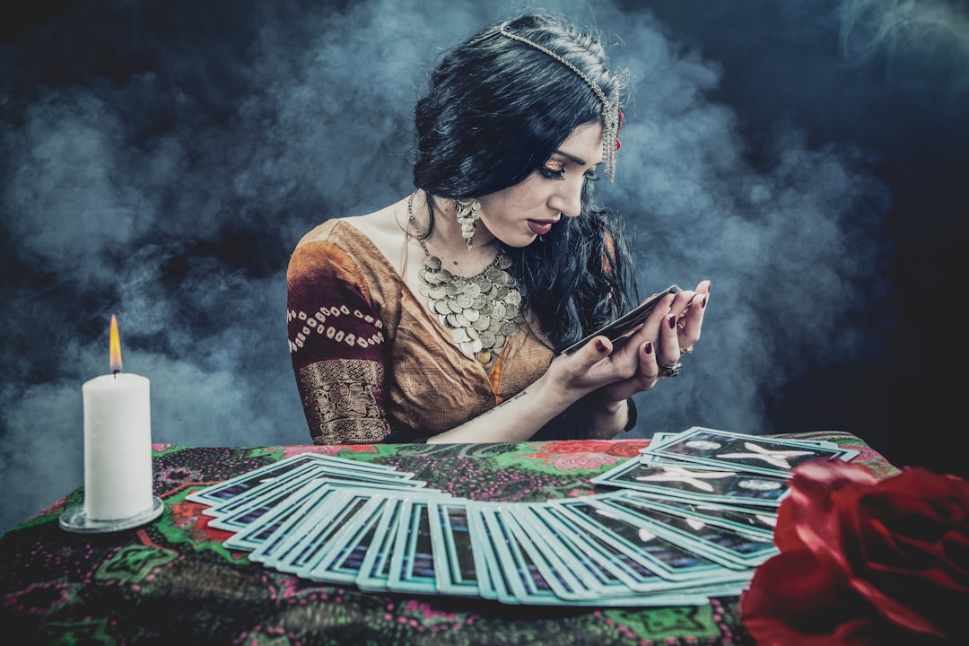 woman in brown and black floral dress sitting on red and white textile