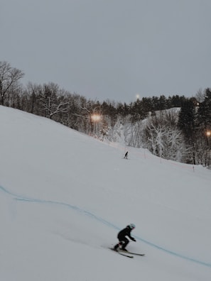 Skiers racing down a snowy hill during a competition.