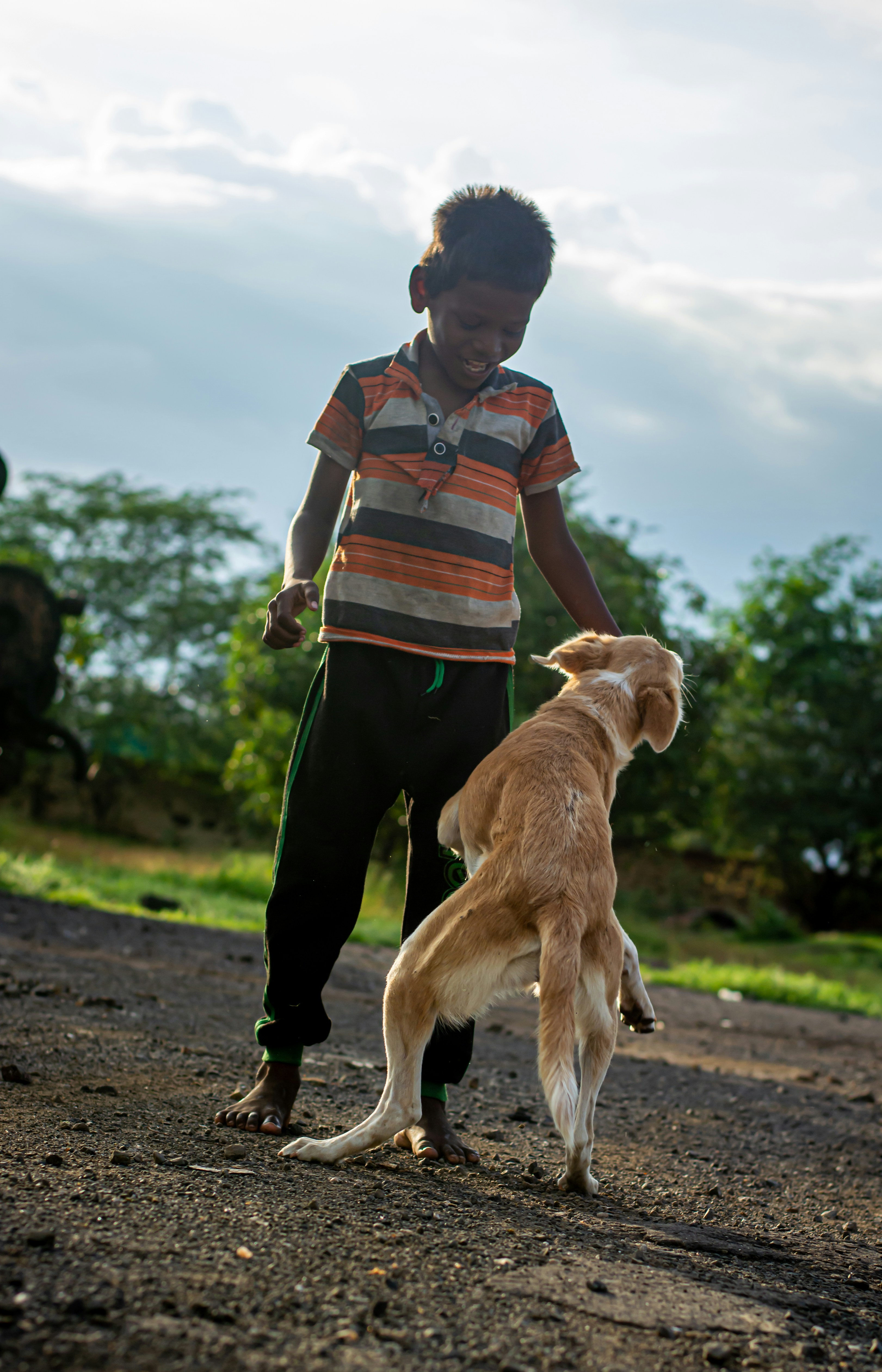 man in red blue and yellow plaid shirt and black pants with black pants standing beside