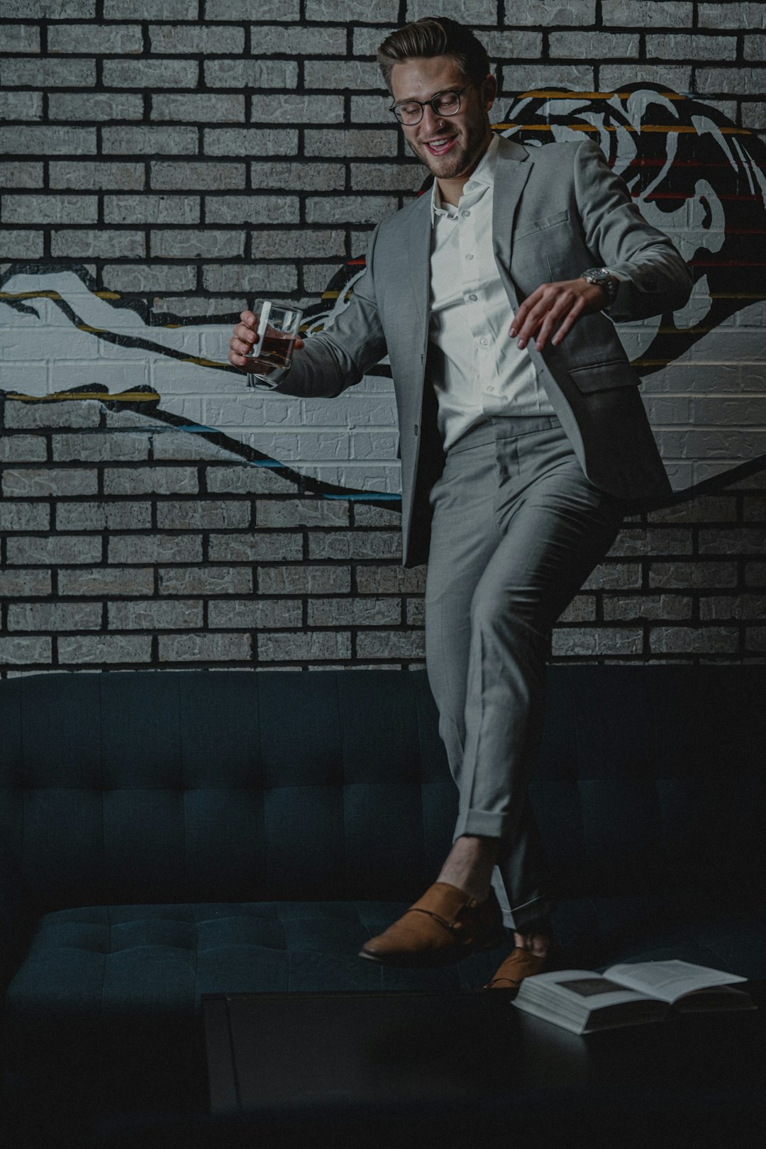 man in blue blazer and gray pants holding stick