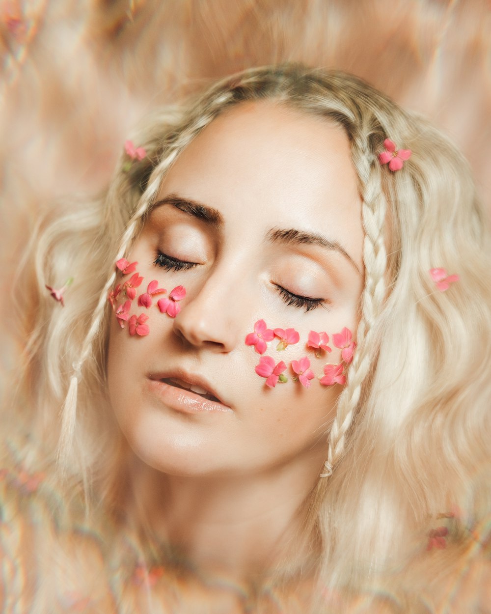 woman with pink and white flower on her face