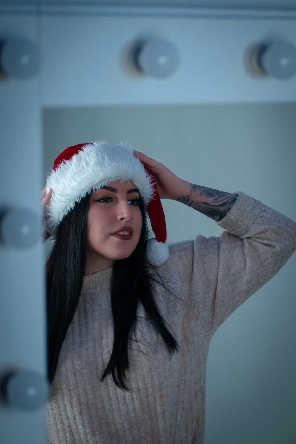 woman in gray long sleeve shirt wearing santa hat