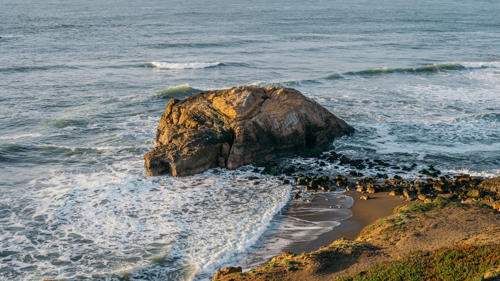 brown rock formation on sea shore during daytime