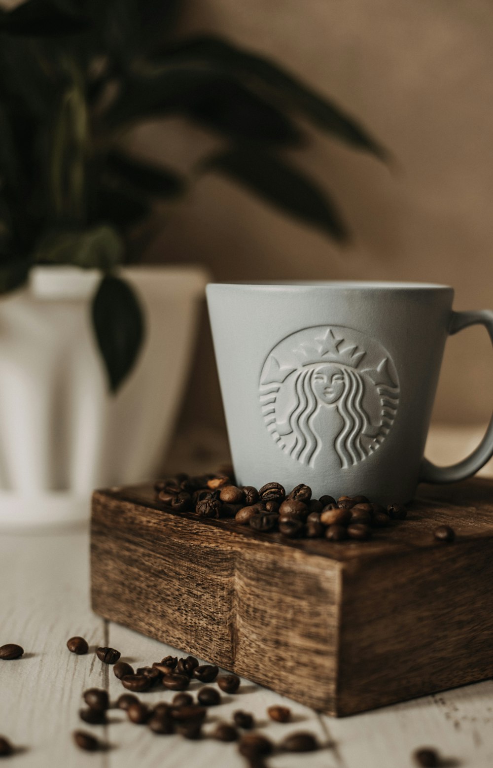 white ceramic mug on brown wooden table