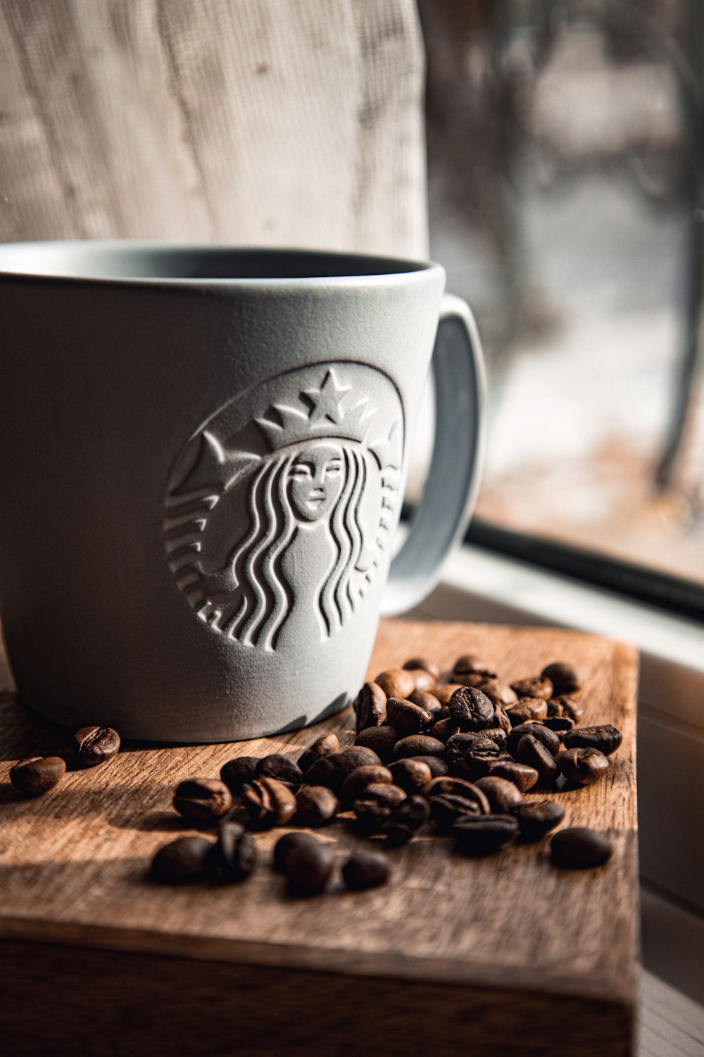 white ceramic mug on brown wooden table