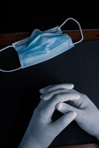 person holding blue textile on black table