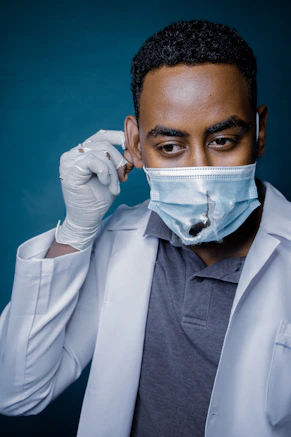 man in white dress shirt with white face mask