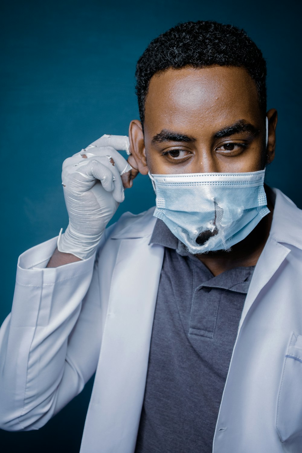 man in white dress shirt with white face mask