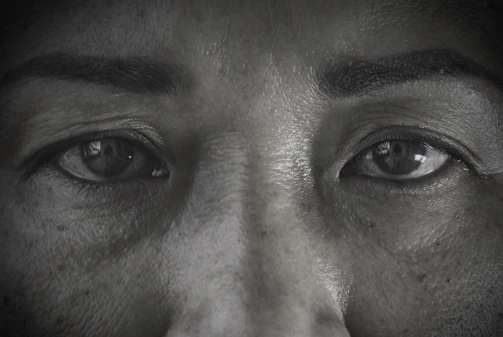 Close-up of a 3D scanner device capturing detailed contours of a person's face.