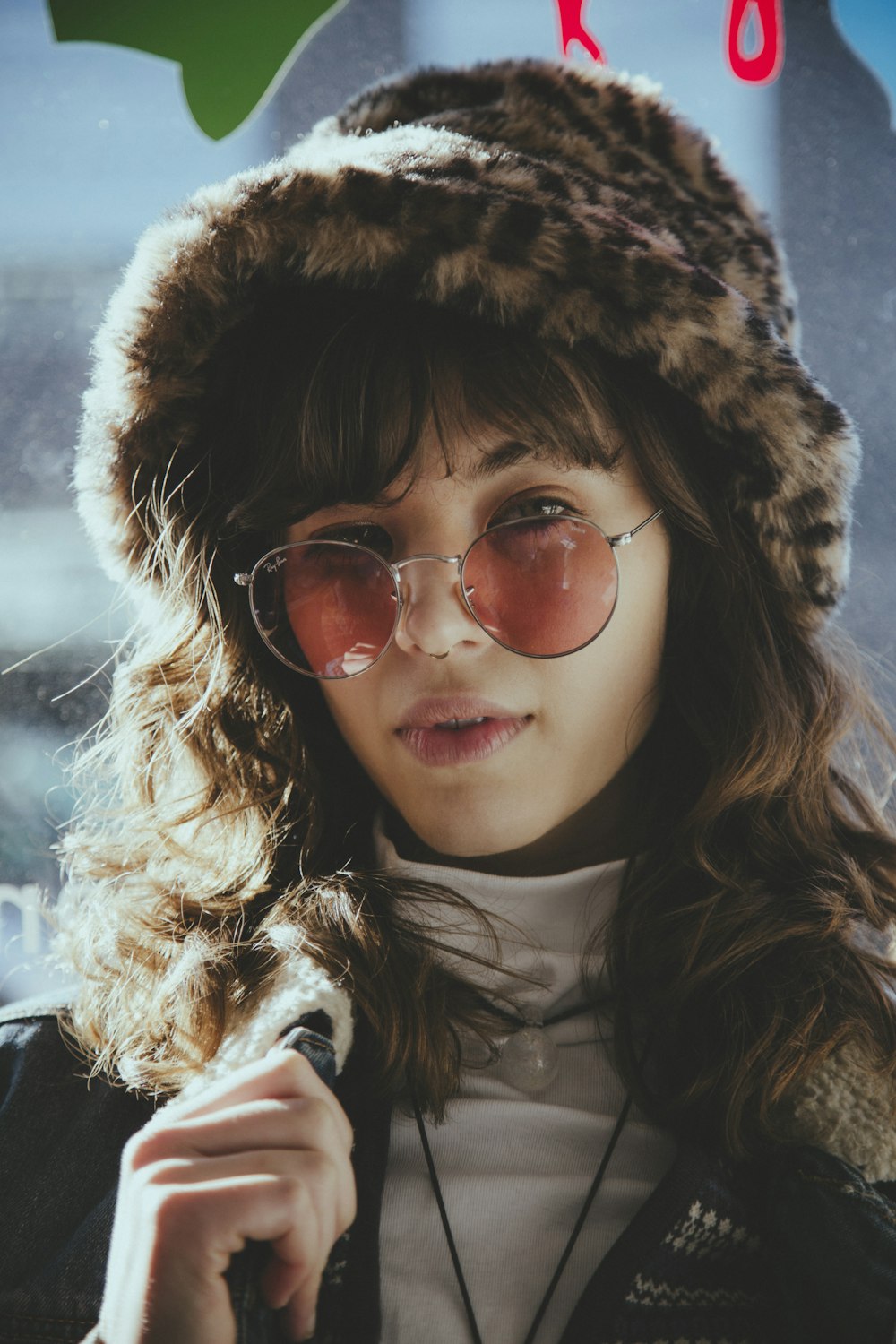 woman in brown fur jacket wearing brown aviator sunglasses