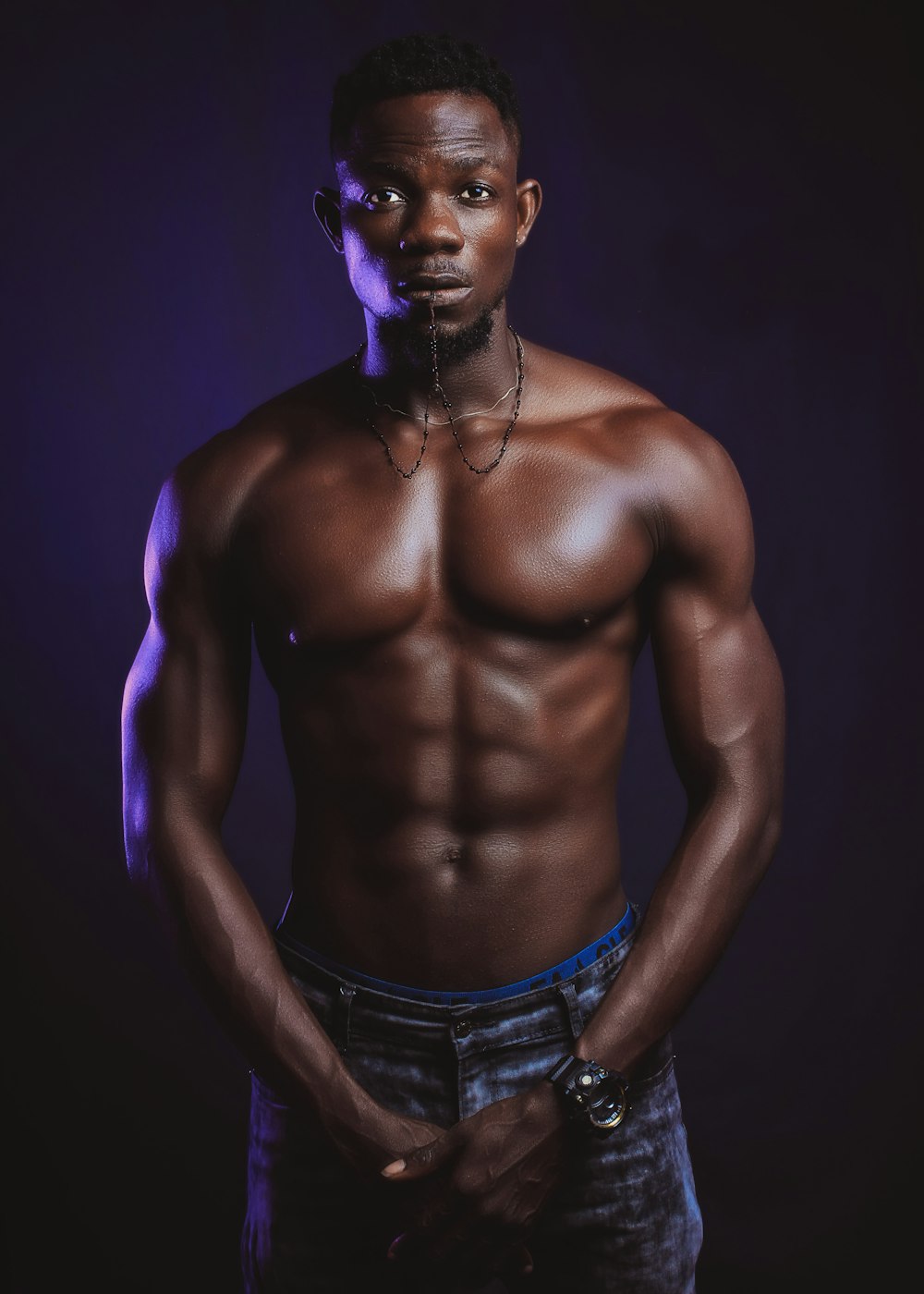 topless man wearing blue denim jeans