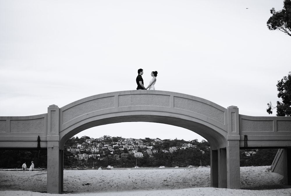 man standing on arch bridge during daytime