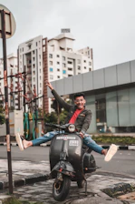 A young person happily riding an electric scooter through a vibrant city street.