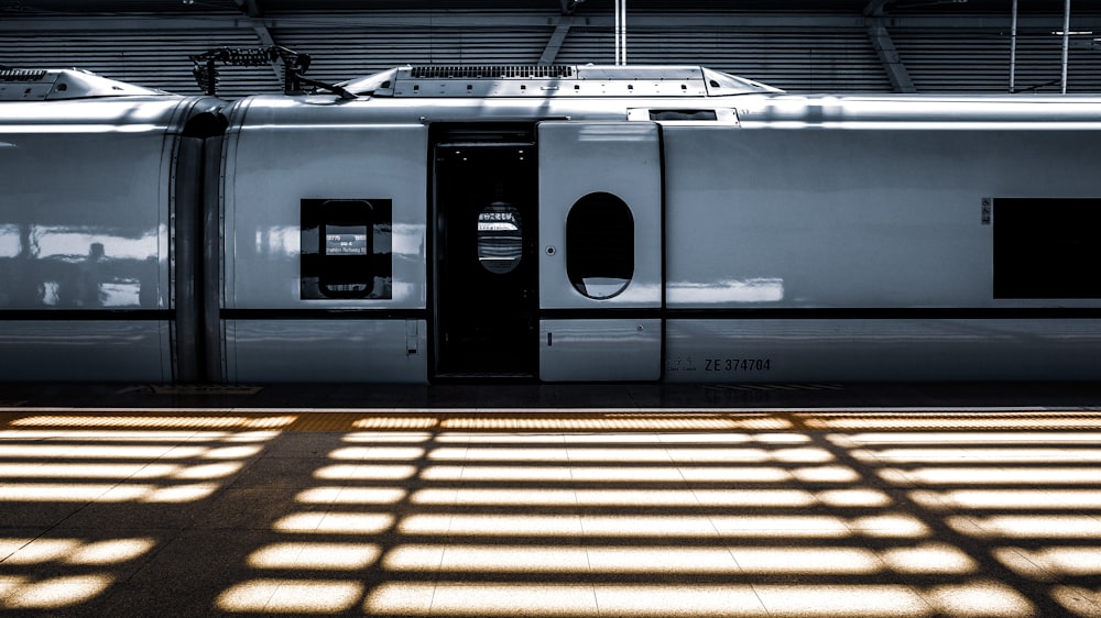 white and black train in a train station