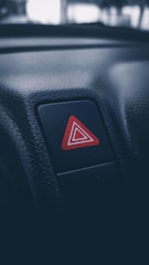 a red triangle sticker on a car dashboard