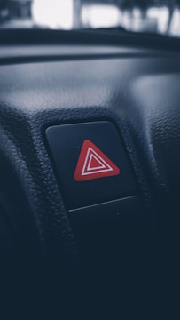a red triangle sticker on a car dashboard