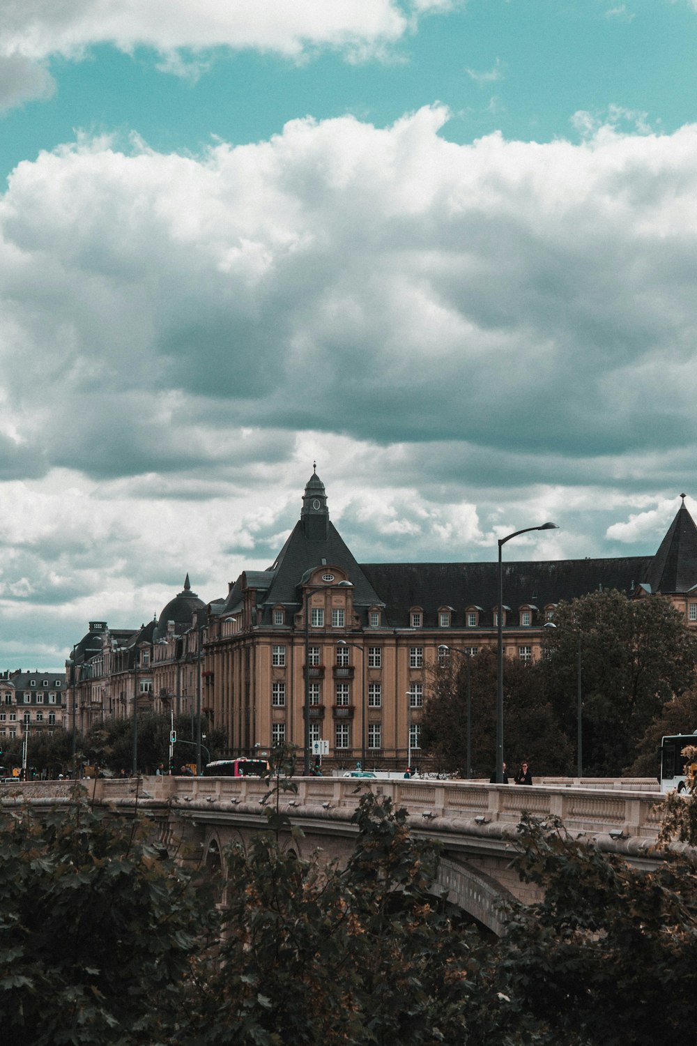 brown and black concrete building under white clouds during daytime