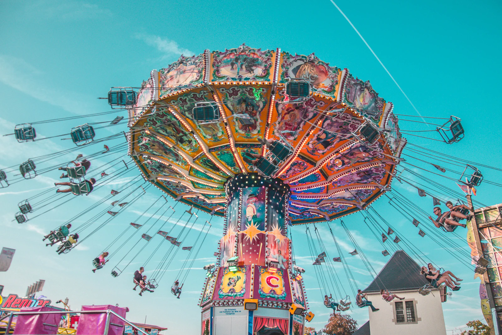 Familles sur un carrousel coloré dans un parc d'attractions.