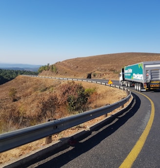 white and blue truck on road during daytime