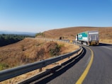 Close-up of a heavy-duty truck navigating a winding road.