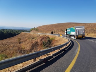 white and blue truck on road during daytime